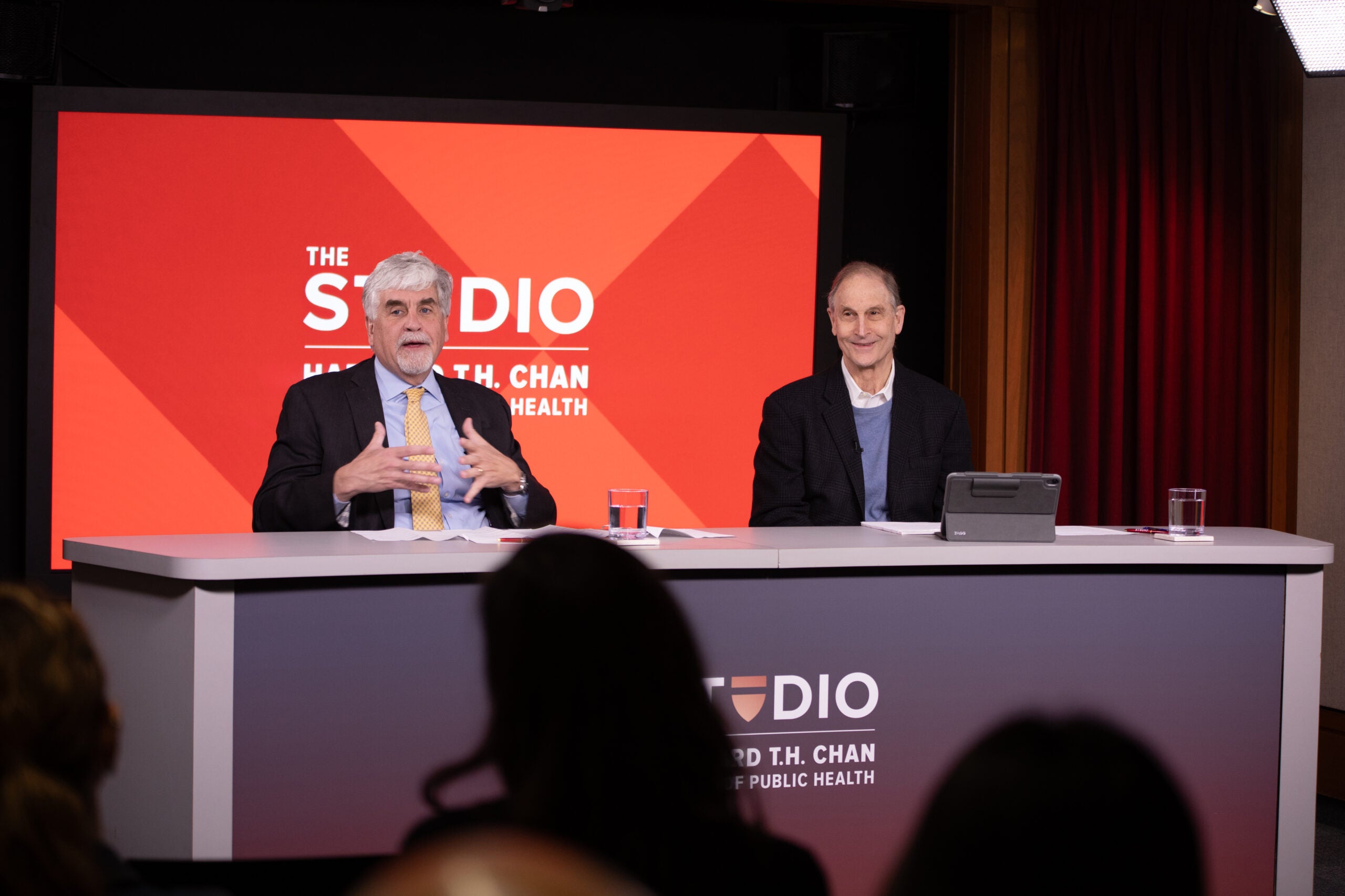 Eric Hargan (left) speaks at the Harvard Chan Studio. David Blumenthal is to his right.